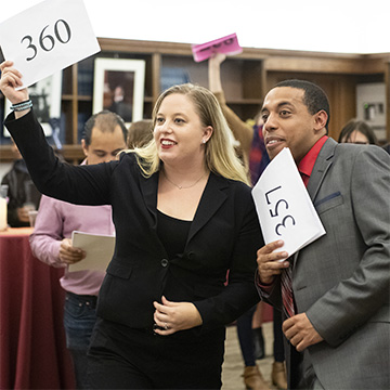 Law student Abby Marchinkoski and friend Tavis Fitzpatrick during bidding at the annual PILG Auction, which supports public interest fellowships.