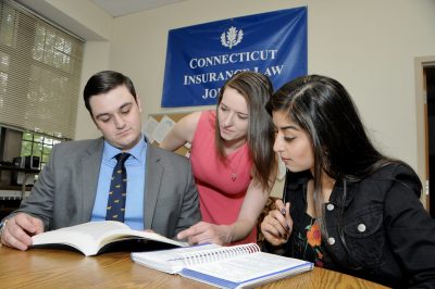 people in business attire under banner reading Connecticut Insurance Law Journal