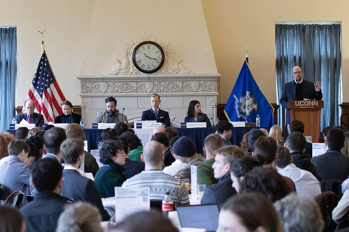Panel of 5 people in front of crowd