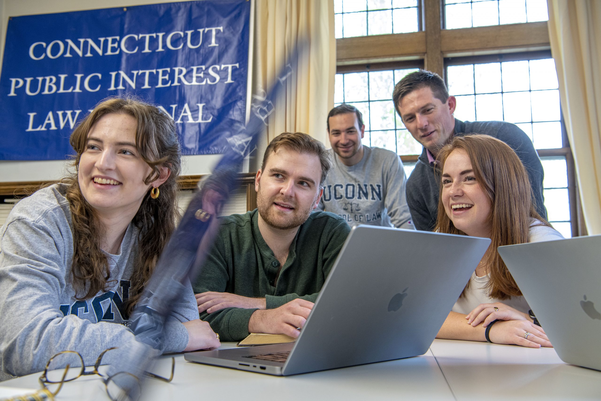 Group of students behind laptops