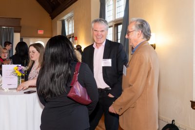 Alumni and student chatting