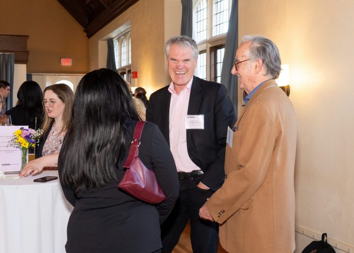 Alumni and student chatting