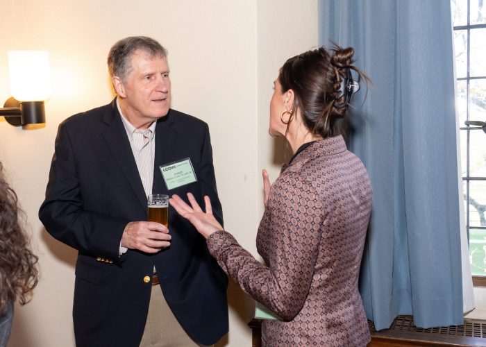 Alumni and student chatting