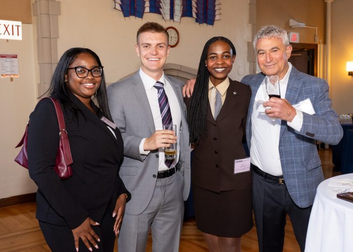 Alumni and student smiling