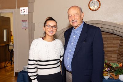 Alumni and student smiling