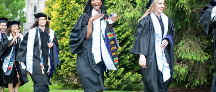 Graduates in a line on the grass