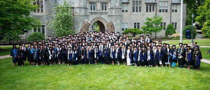 A group of graduates in front of the law library